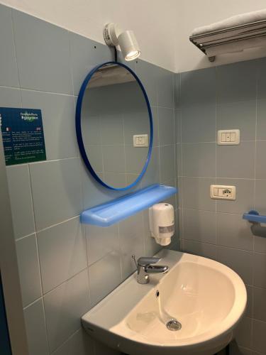 a bathroom with a sink and a mirror at Ostello Del Porto in Lovere