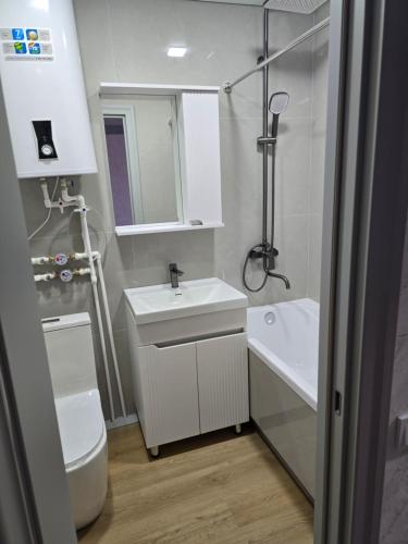 a small bathroom with a sink and a toilet at Возле Нарыка in Ekibastuz