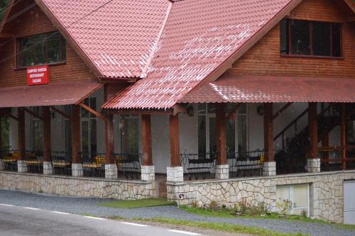 a building with red roofs on the side of it at Vila Vanesa in Arieşeni