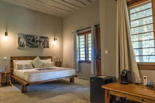a bedroom with a large bed and a window at NDAME Paje Hotel in Paje