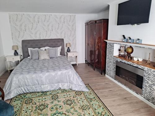 a bedroom with a bed and a fireplace at Casa Do Cais in Setúbal