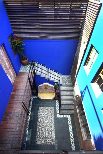 an overhead view of a patio with blue walls and stairs at The Grey Hotel in Cape Town
