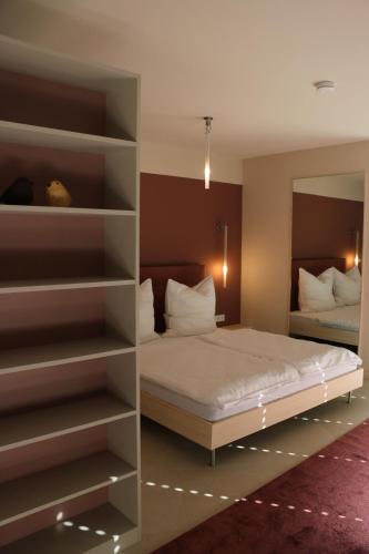 a bedroom with a bed and a book shelf at Rex Palast in Memmingen