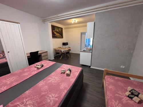 a room with two beds and a kitchen with a table at Ela in Žusterna