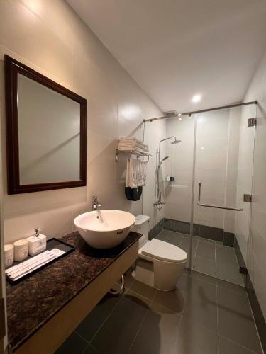 a bathroom with a sink and a toilet and a shower at Glory Hotel in Can Tho