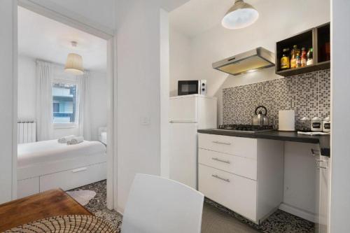 a white kitchen with a sink and a toilet at Venezia, 15 minutes from Venice, Parking,Shuttle airport, Train station Miranese in Mestre