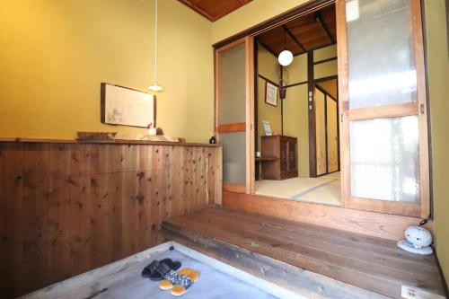 a room with a large mirror and a wooden floor at TSUDOYA Tennoji 集家天王寺 in Osaka
