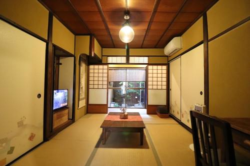 a room with a table in the middle of a room at TSUDOYA Tennoji 集家天王寺 in Osaka