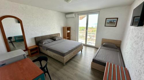 a bedroom with a bed and a table and a window at Villa Megdani B in Ohrid