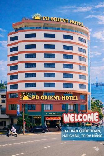 a large hotel with a sign on top of it at Center Orient Hotel in Danang