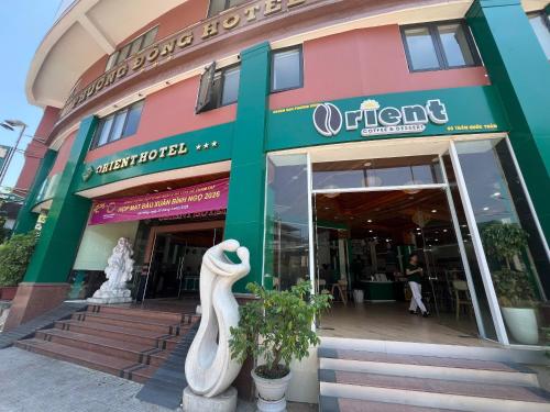 a store front with a statue in front of it at Center Orient Hotel in Danang