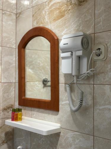 a bathroom with a mirror and a hair dryer at Villa Megdani B in Ohrid