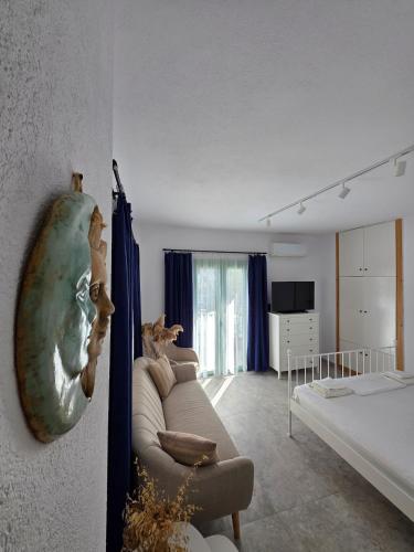 a living room with a couch and a bed at Sun & Moon Studio Afitos in Afitos