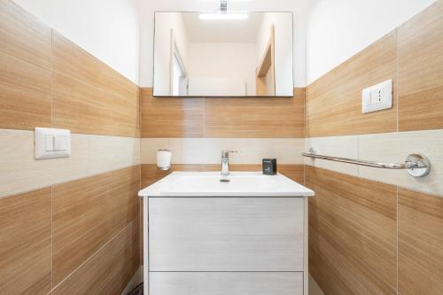 a bathroom with a white sink and a mirror at Central Terrace, Pula in Pula