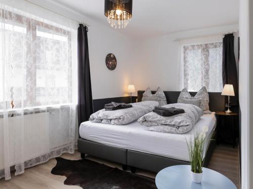 a bedroom with a large bed and a table at Gasthof Barlida in Lainach