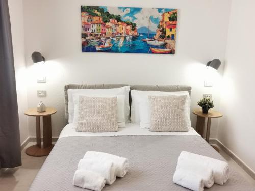 a bedroom with a bed with two white pillows at Domus Luna in Teulada