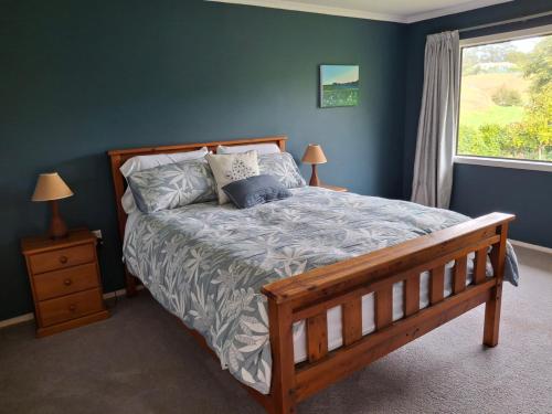 a bedroom with a large bed with a window at Wheel Inn in New Plymouth