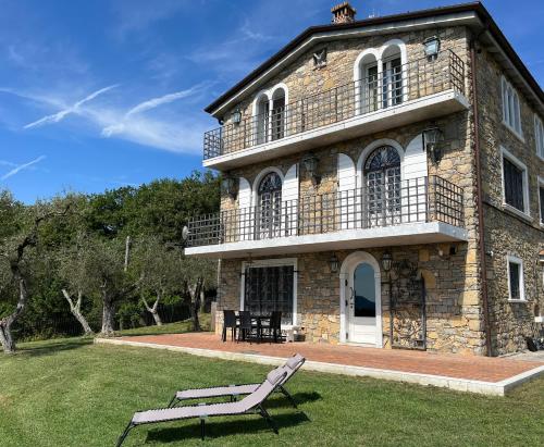 a stone house with a bench in front of it at Alla Fortezza in Sarzana