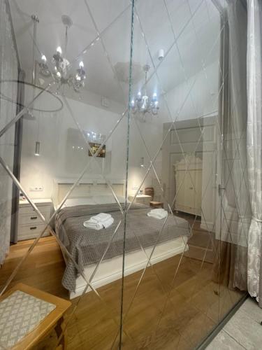 a room with a bed and a glass wall at Villa Langberg Spa in Ventspils