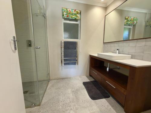 a bathroom with a sink and a shower at Misty Moon in Malgas
