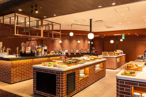 a restaurant with a buffet line with food at Hotel Keihan Kyoto Grande in Kyoto