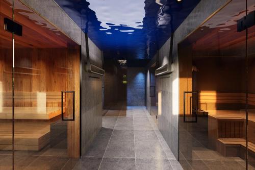 a hallway with a blue ceiling and wooden walls at Hotel Central - das kleine Boutique Hotel am Achensee in Pertisau