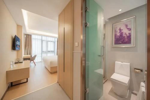 a bathroom with a shower and a toilet in a room at Lavande Hotel Xi'an Bell Tower in Xi'an