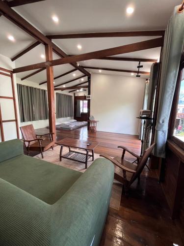 a living room with a couch and a table at ค้างคาวกินกล้วยโฮมสเตย์ in Ban Mung