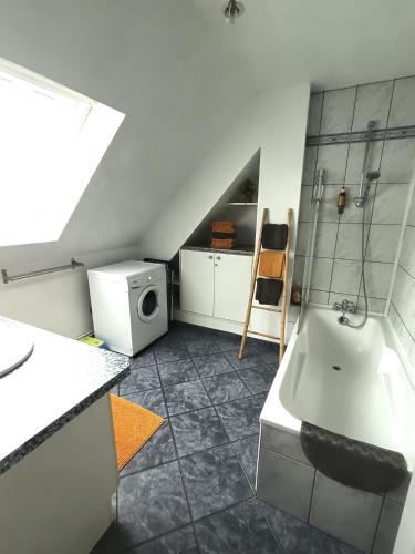 a bathroom with a shower and a sink and a microwave at A l'Orée du Bois ''Les Hêtres'' in Guewenheim