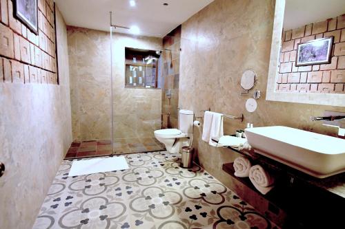 a bathroom with a sink and a toilet at Arbor Road Estate in Pāmalparti