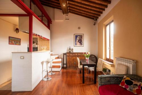 a kitchen and living room with a table and chairs at Il NIDO-Attico Siena Centro con vista Duomo e Torre Del Mangia in Siena