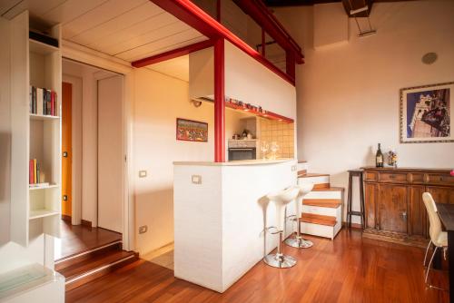 a kitchen with a white island in a room at Il NIDO-Attico Siena Centro con vista Duomo e Torre Del Mangia in Siena