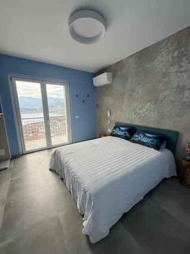 a bedroom with a large bed with a large window at Il Cubo di Anja Home of amazing view in Pisogne
