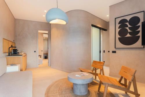 a living room with a table and chairs at Beau Rivage Suites in Lóngos