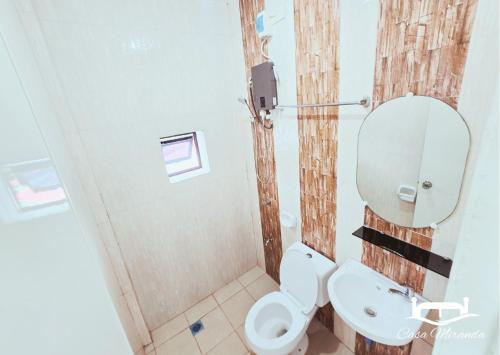 a bathroom with a toilet and a shower at Casa-Miranda Homestay in Daet