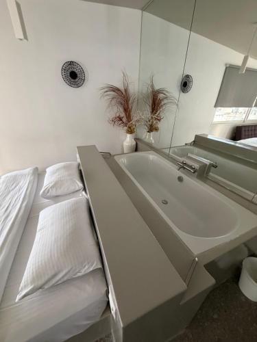 a white bathroom with a sink and a mirror at athensdot in Athens