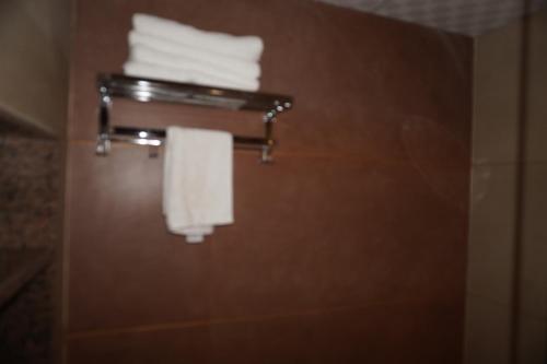 a bathroom with a towel rack with towels at Neendar Heritage Resort in Jaipur