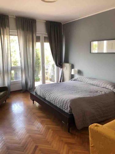 a bedroom with a large bed and windows at Splendid Lido in Venice-Lido