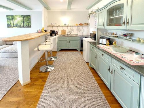 a kitchen with blue cabinets and a counter at Zach Waldglück in Groß Klessow