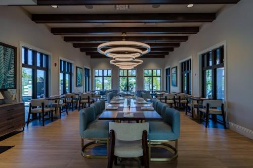 a large dining room with a long table and chairs at 9 BD 6.5 BA Solara Resort 9028 FK in Orlando