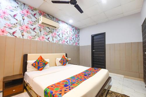 a bedroom with a bed and a floral wall at Via The Arrow in New Delhi