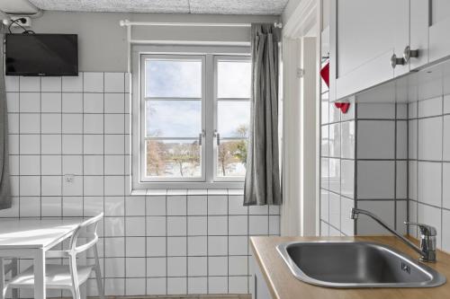 a kitchen with a sink and a window at Sorø Camping & Cottages in Sorø
