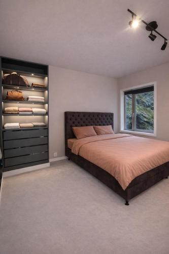 a bedroom with a bed and a closet at Bergen Apartment with a view in Bergen