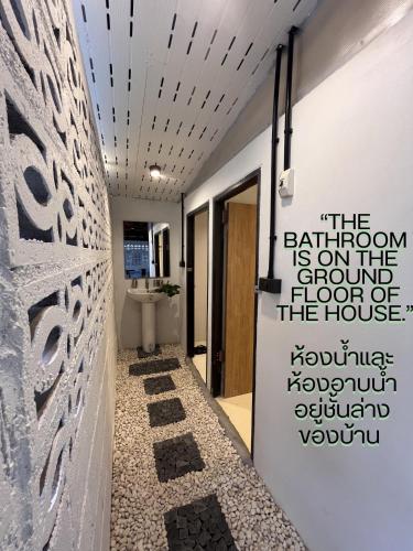 a hallway with a wall with a sign on it at ค้างคาวกินกล้วยโฮมสเตย์ in Ban Mung