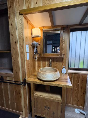 a bathroom in a tiny house with a sink at 指宿古民家宿 in Ibusuki