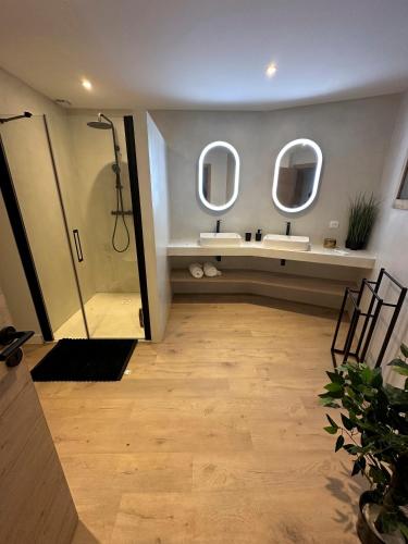 a bathroom with two sinks and two mirrors at Villa ALDAKETA in Urrugne
