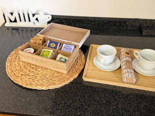 a table with a tray with a cup and a tea set at Incanto dei sibillini- Piazza Perfetti 16 in Sarnano