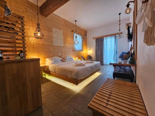 a bedroom with a bed in a room with wooden walls at Penélope Hotel in Ialysos