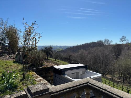 a bath tub sitting on top of a balcony at Lacouty le paradis! in Junhac