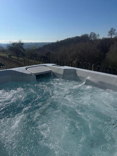 a swimming pool with a water slide at Lacouty le paradis! in Junhac
